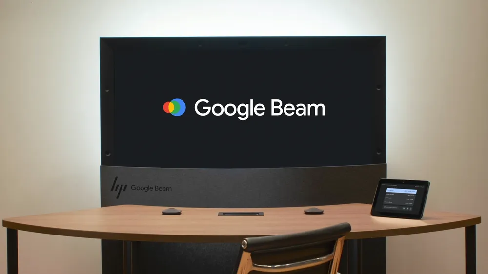 Life-sized 3D video call using Google Beam technology in a modern office setting.